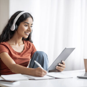 Student Young Indian Woman Using Digital Tablet, Headphones