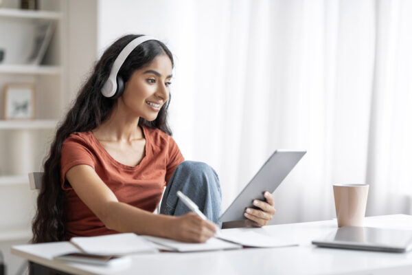 Student Young Indian Woman Using Digital Tablet, Headphones